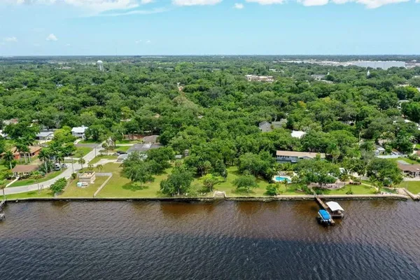 an aerial view of ocean with residential houses with outdoor space