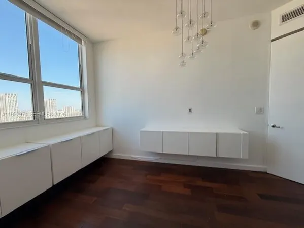 a room with a window and wooden floor
