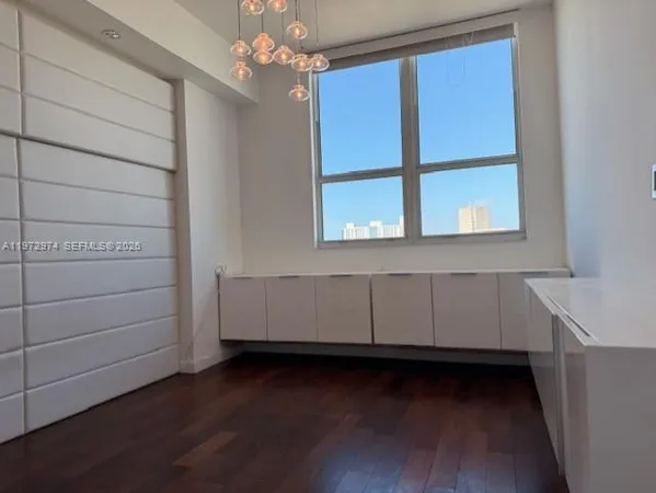 a view of room with window and hardwood floor