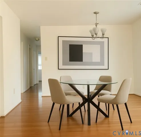 a view of a dining room with furniture and wooden floor
