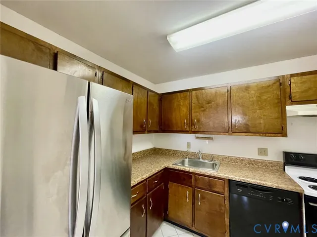 a kitchen with a sink and a refrigerator
