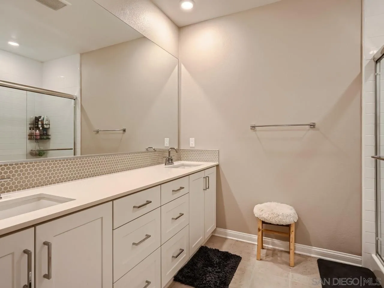 2021 Bluestone Circle Chula Vista, CA 91913 - Photo 13 of 22 a bathroom with a double vanity sink a toilet and a mirror
