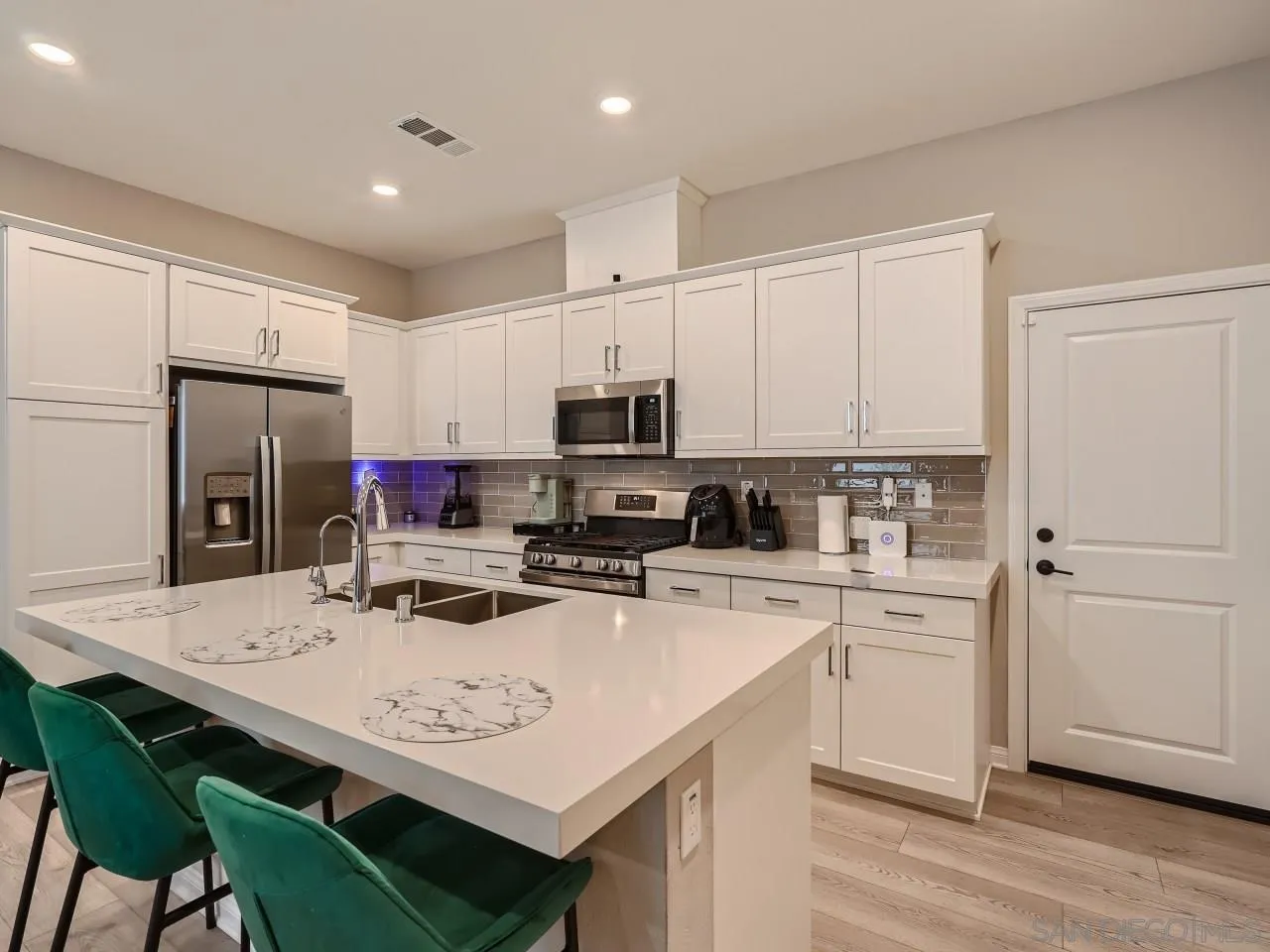 2021 Bluestone Circle Chula Vista, CA 91913 - Photo 6 of 22 a kitchen with refrigerator cabinets and wooden floor