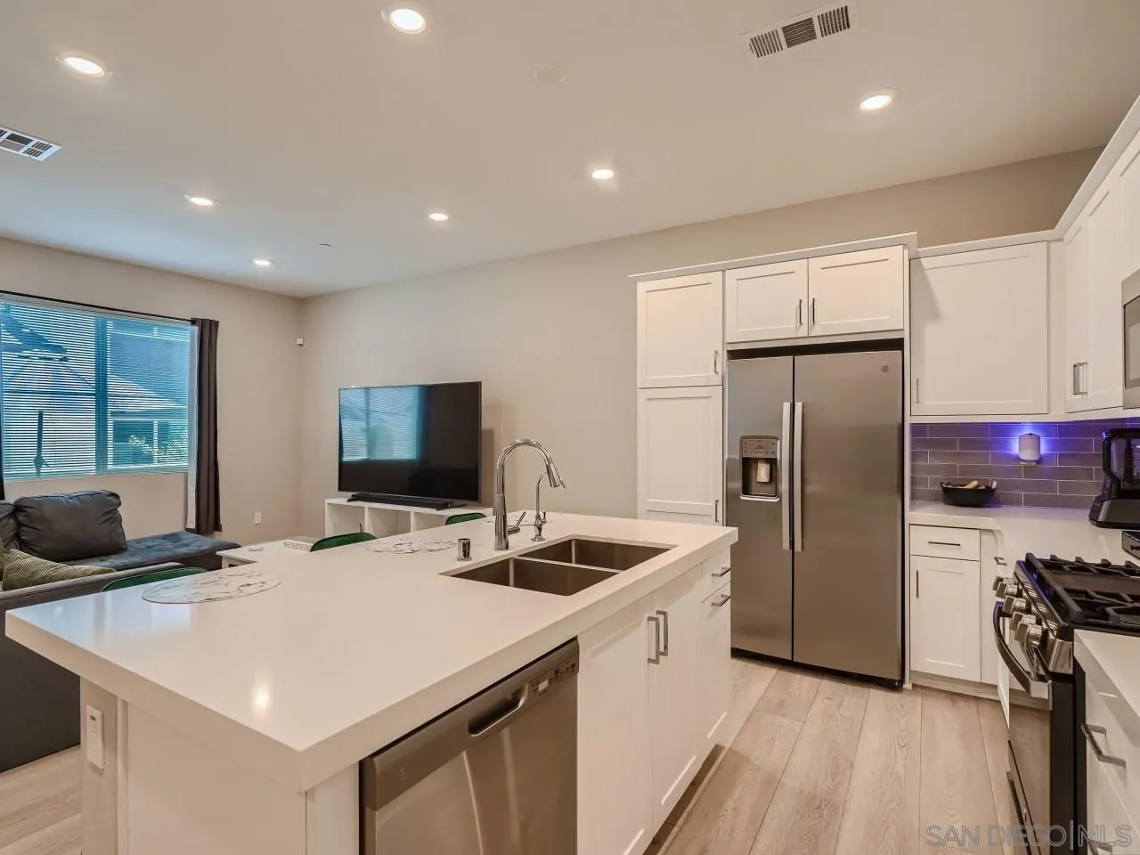 2021 Bluestone Circle Chula Vista, CA 91913 - Photo 8 of 22 a kitchen with stainless steel appliances a refrigerator sink and wooden floor