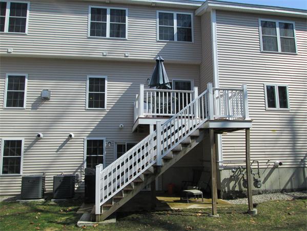 6 B Charles Ridge Road, Unit B Littleton, MA 01460 - Photo 15 of 16 a view of a house with a deck