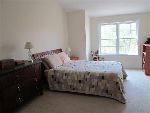 6 B Charles Ridge Road, Unit B Littleton, MA 01460 - Photo 10 of 16 a bed sitting in a bedroom next to a window