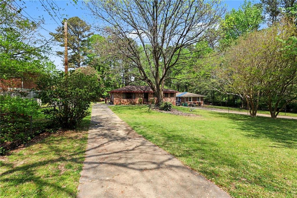 7019 Lake View Lane Doraville, GA 30360 - Photo 3 of 32 a front view of a house with garden