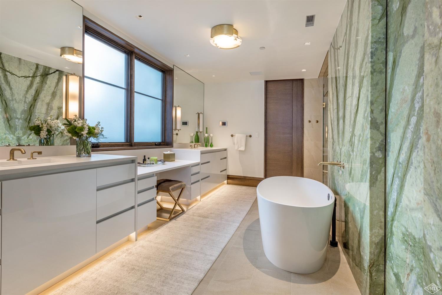 2950 Booth Creek Drive Vail, CO 81657 - Photo 16 of 25 a spacious bathroom with a double vanity sink a mirror and a bathtub