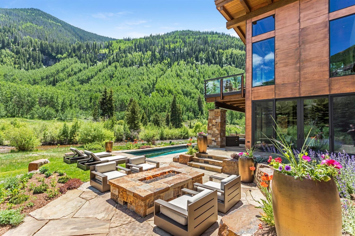 2950 Booth Creek Drive Vail, CO 81657 - Photo 18 of 25 a view of a chairs and table in a backyard
