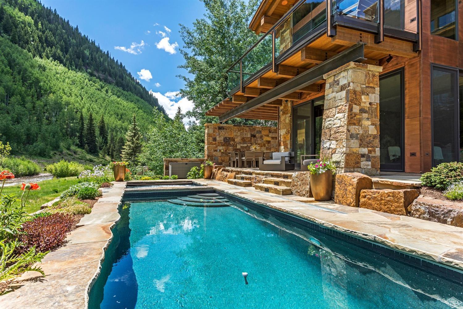 2950 Booth Creek Drive Vail, CO 81657 - Photo 20 of 25 a swimming pool with outdoor seating and yard