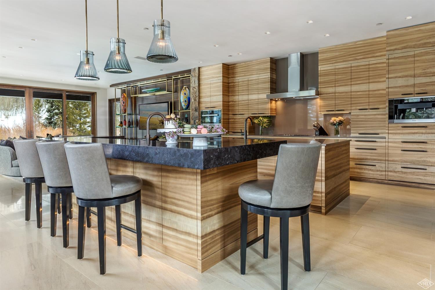 2950 Booth Creek Drive Vail, CO 81657 - Photo 7 of 25 a dining table with chairs and a chandelier