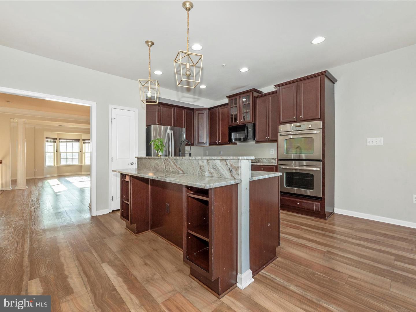 208 B Mill Pond Road Frederick, MD 21701 - Photo 9 of 45 a large kitchen with stainless steel appliances granite countertop wooden cabinets a center island and a wooden floor