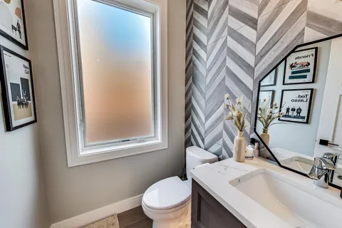 a bathroom with a toilet a sink and a mirror