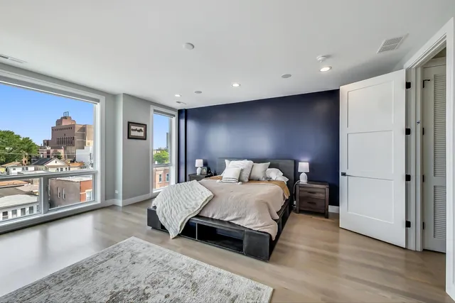 a bedroom with a large bed and a couch