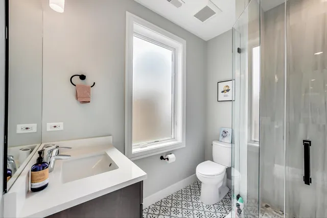 a bathroom with a sink toilet and shower