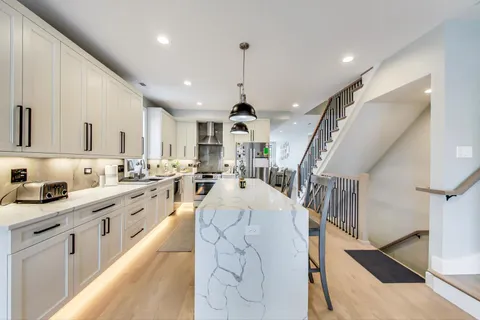 a large white kitchen with lots of counter top space
