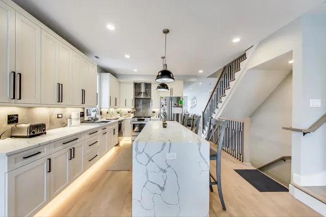a large white kitchen with lots of counter top space