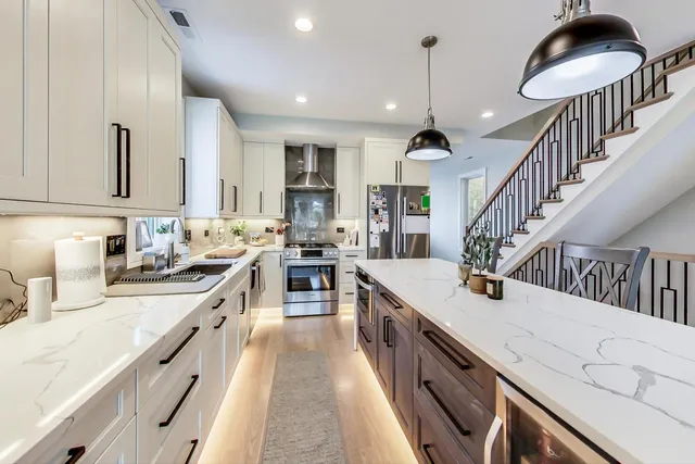 a kitchen with sink stove and cabinets