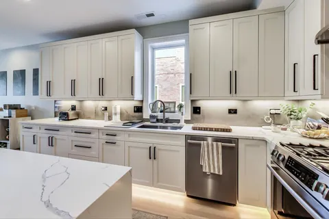 a kitchen with appliances a sink and cabinets