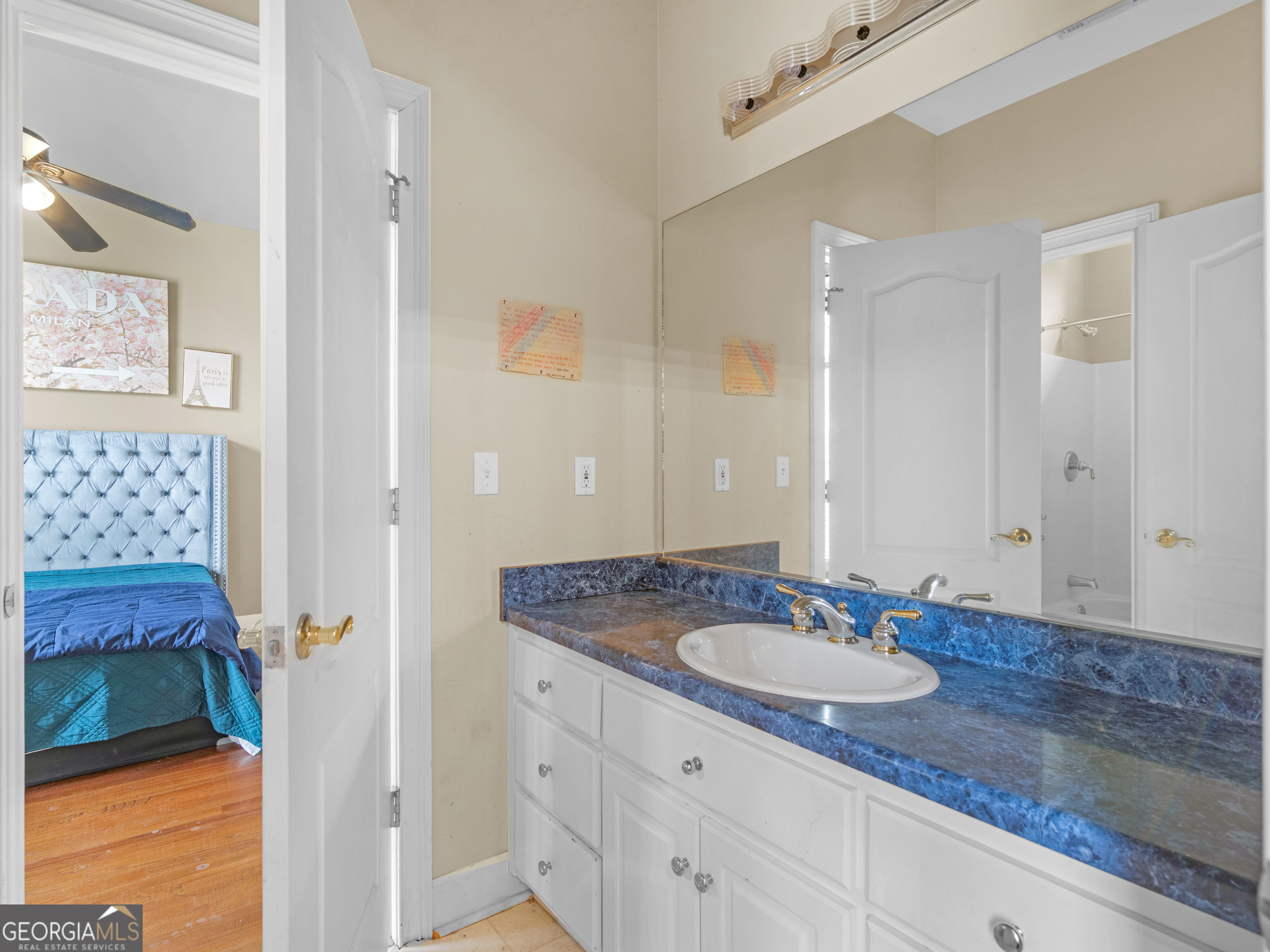 517 North Pine Hill Road Griffin, GA 30223 - Photo 16 of 25 a bathroom with a granite countertop sink and a mirror