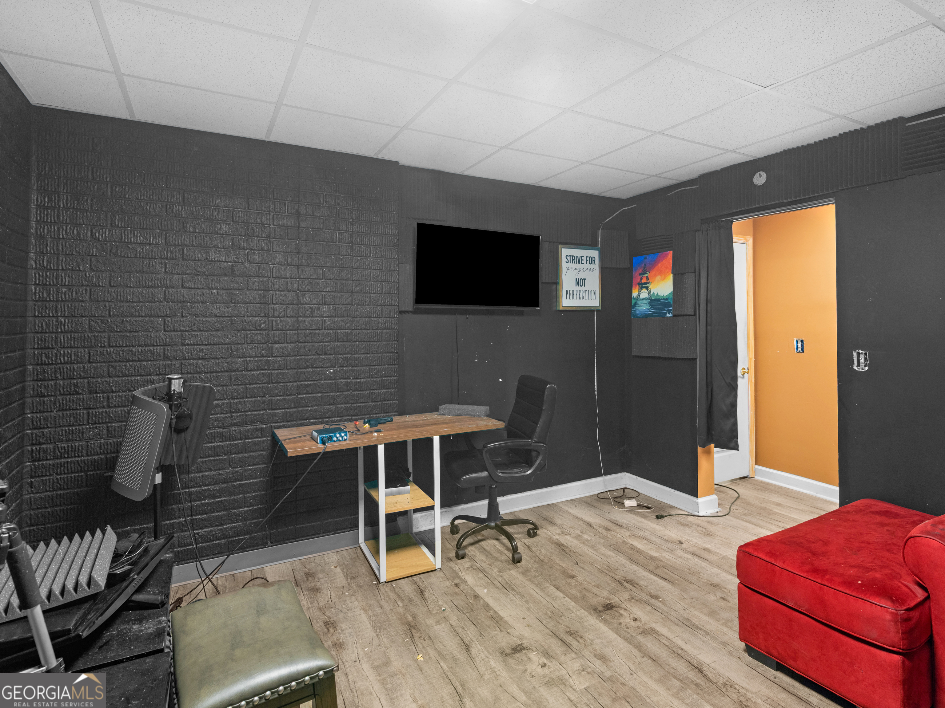 517 North Pine Hill Road Griffin, GA 30223 - Photo 22 of 25 a workspace with furniture and a flat screen tv