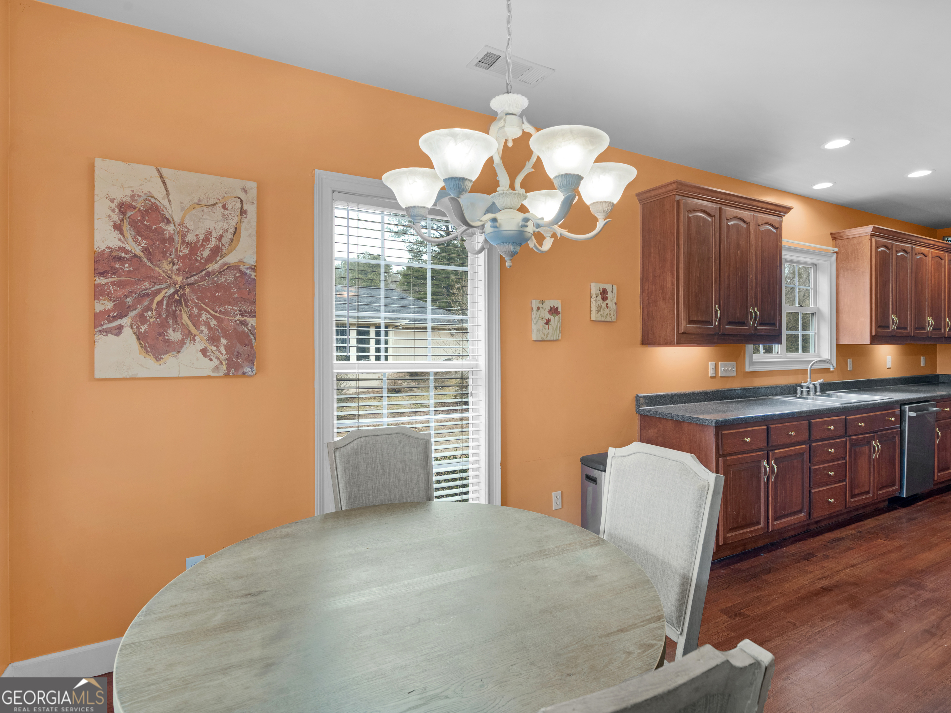 517 North Pine Hill Road Griffin, GA 30223 - Photo 8 of 25 a kitchen with stainless steel appliances granite countertop a stove a sink dishwasher and a dining table with wooden floor