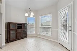 a view of a kitchen with cabinet and refrigerator