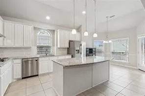 a kitchen with stainless steel appliances granite countertop a sink and cabinets