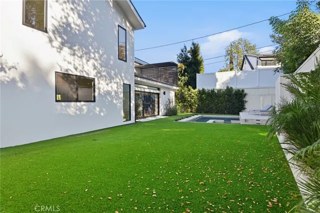 a front view of a house with a yard and a garage