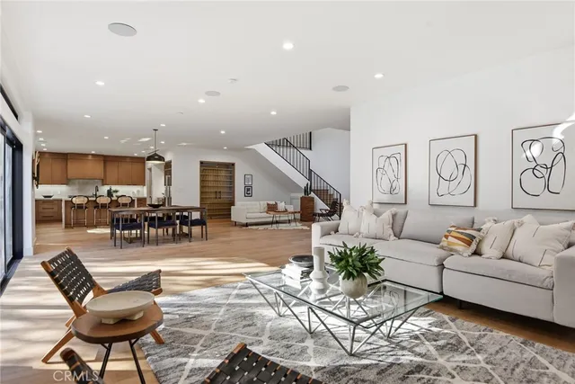 a living room with furniture and kitchen view