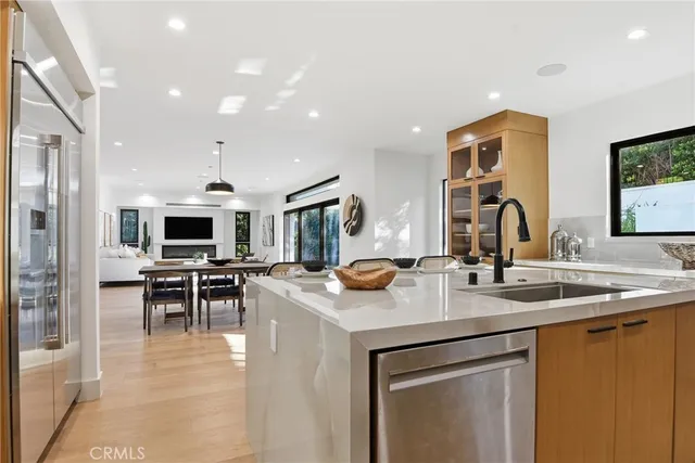 a kitchen with a sink stove and chairs