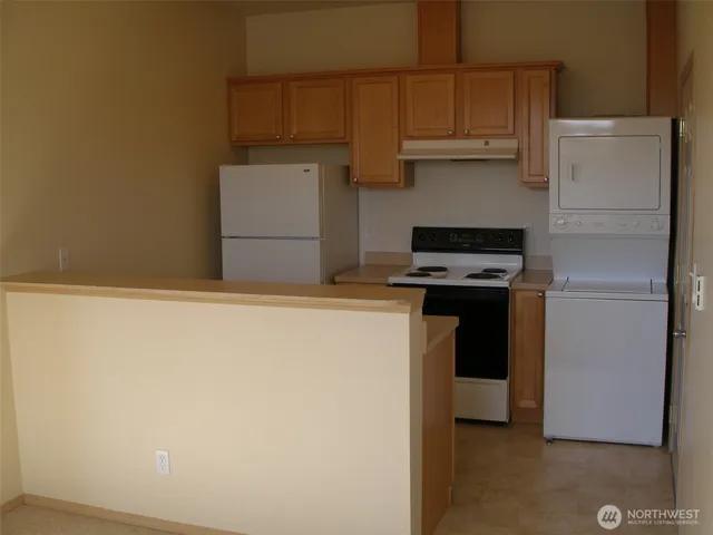 a kitchen with a refrigerator and a stove