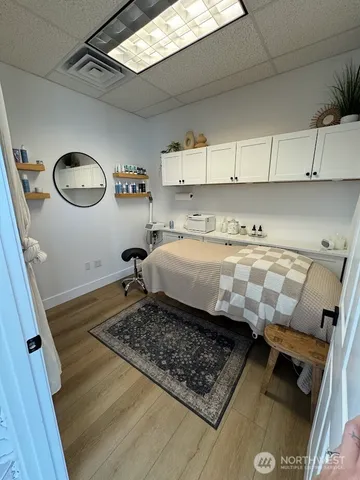 a bed sitting in a kitchen next to a window