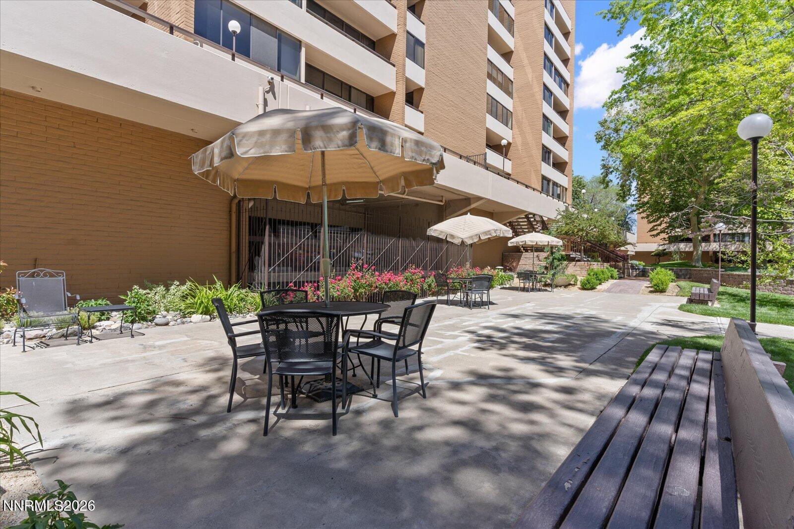 1200 Riverside Drive, Unit 1229 Reno, NV 89503 - Photo 46 of 51 a view of a patio with a table and chairs under an umbrella