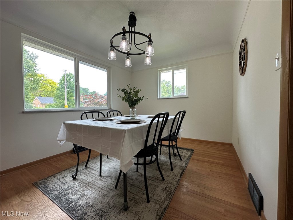 4281 Grannis Road Cleveland, OH 44126 - Photo 13 of 30 Dining area with a chandelier, wood finished floors, and baseboards