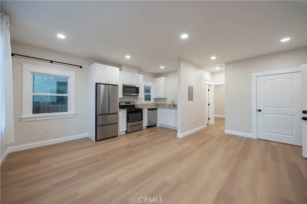 a view of kitchen with stainless steel appliances refrigerator oven and microwave