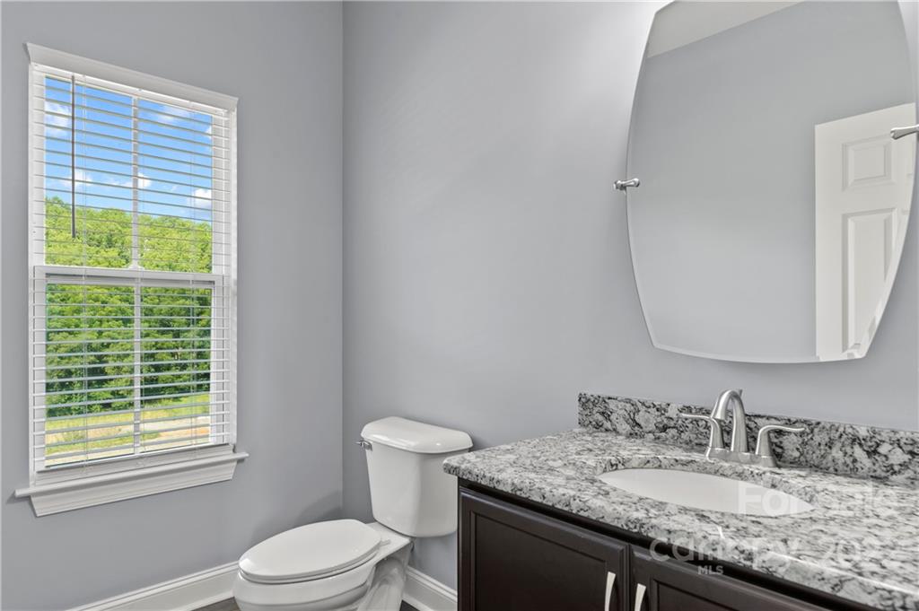 640 Pigeon Ford Road Canton, NC 28716 - Photo 18 of 30 a bathroom with a granite countertop sink toilet and mirror