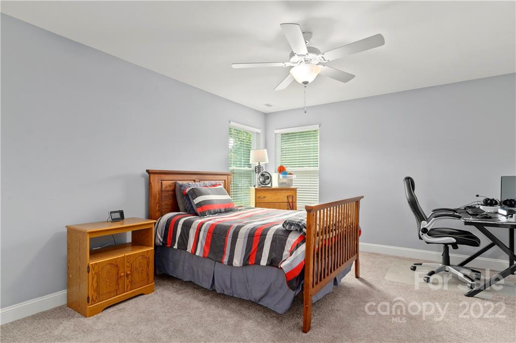 640 Pigeon Ford Road Canton, NC 28716 - Photo 22 of 30 a bedroom with a bed and a chandelier