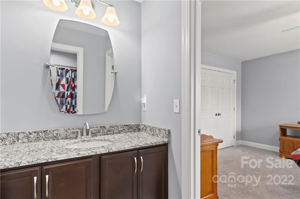 640 Pigeon Ford Road Canton, NC 28716 - Photo 23 of 30 a bathroom with a granite countertop sink and a mirror