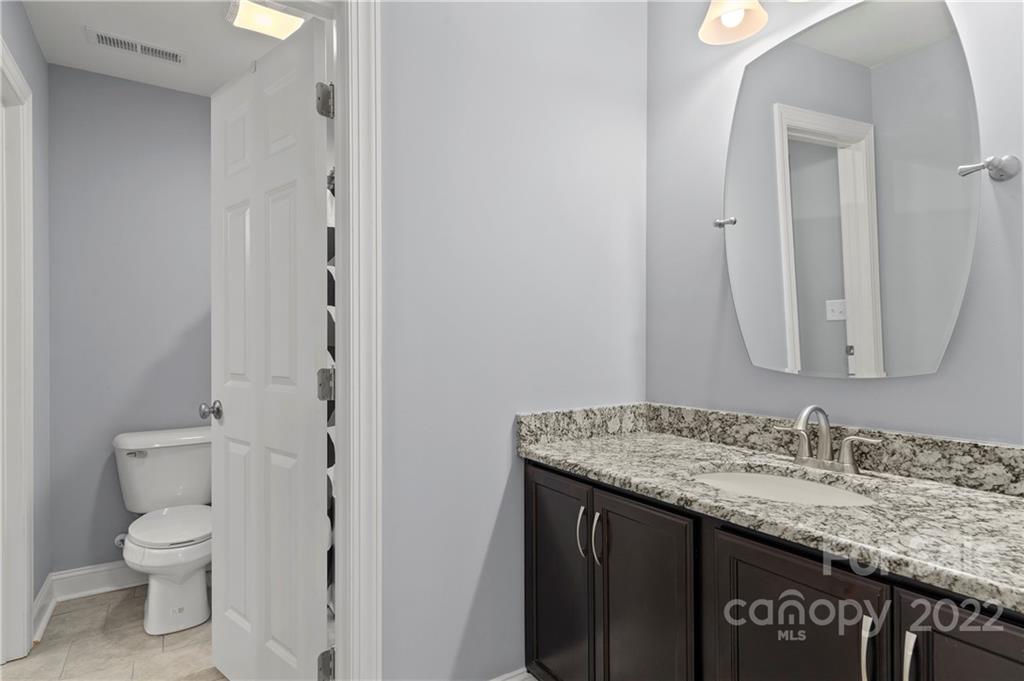 640 Pigeon Ford Road Canton, NC 28716 - Photo 25 of 30 a bathroom with a granite countertop sink and a mirror