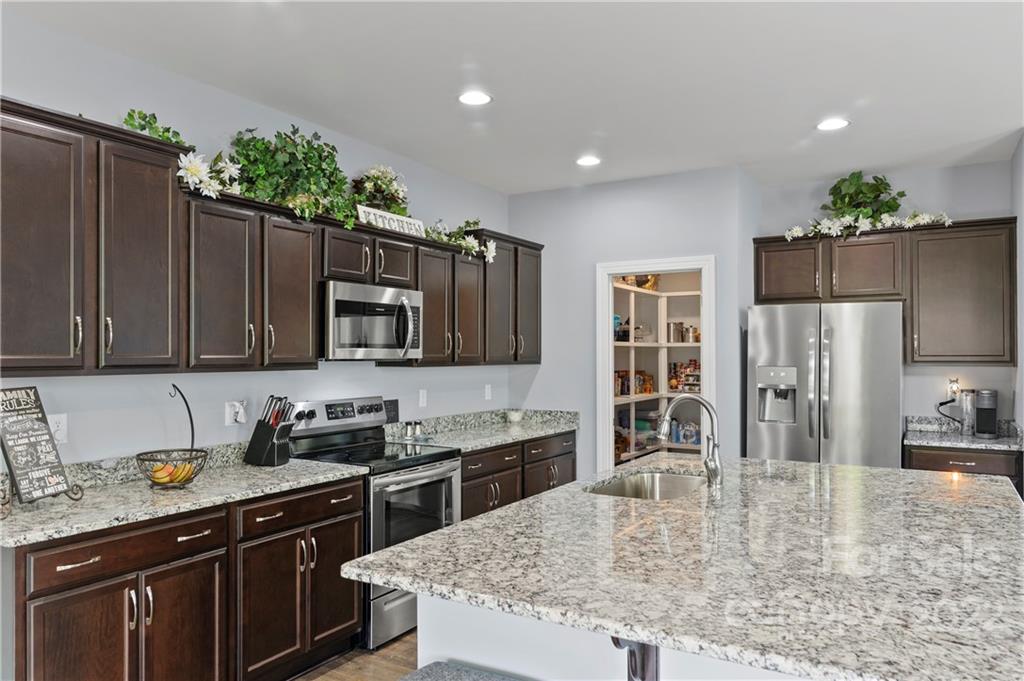 640 Pigeon Ford Road Canton, NC 28716 - Photo 7 of 30 a kitchen with kitchen island granite countertop a stove refrigerator and microwave
