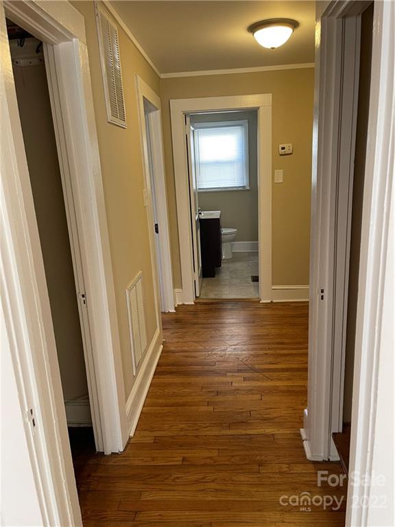 607 Salisbury Road Statesville, NC 28677 - Photo 11 of 20 a view of a hallway with wooden floor and staircase
