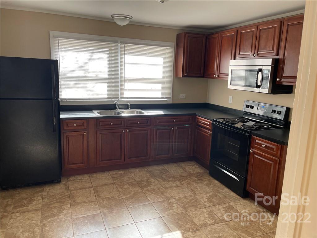 607 Salisbury Road Statesville, NC 28677 - Photo 3 of 20 a kitchen with stainless steel appliances granite countertop a stove a refrigerator and a sink