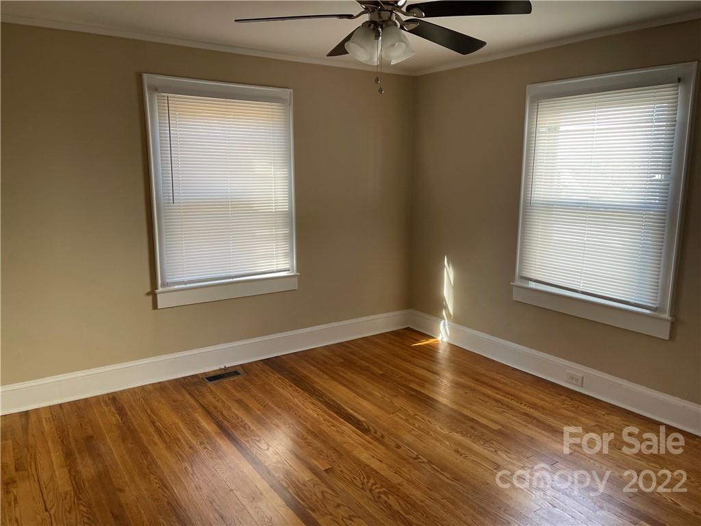 607 Salisbury Road Statesville, NC 28677 - Photo 7 of 20 a view of an empty room with wooden floor and a window