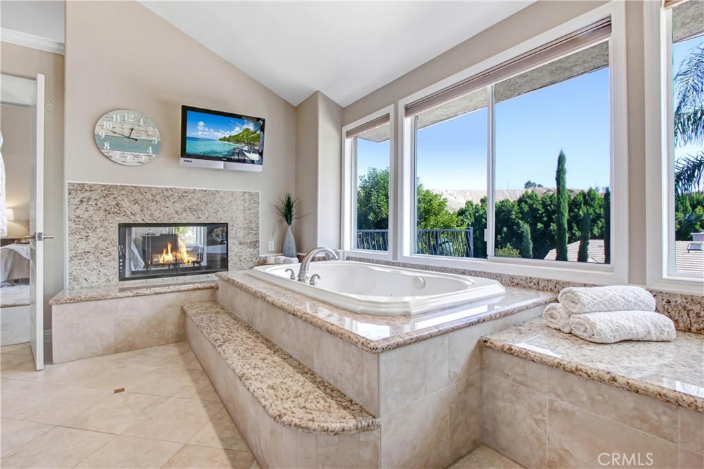 12036 Wood Ranch Road Granada Hills, CA 91344 - Photo 26 of 55 Primary Bath Jacuzzi Tub with fireplace and TV