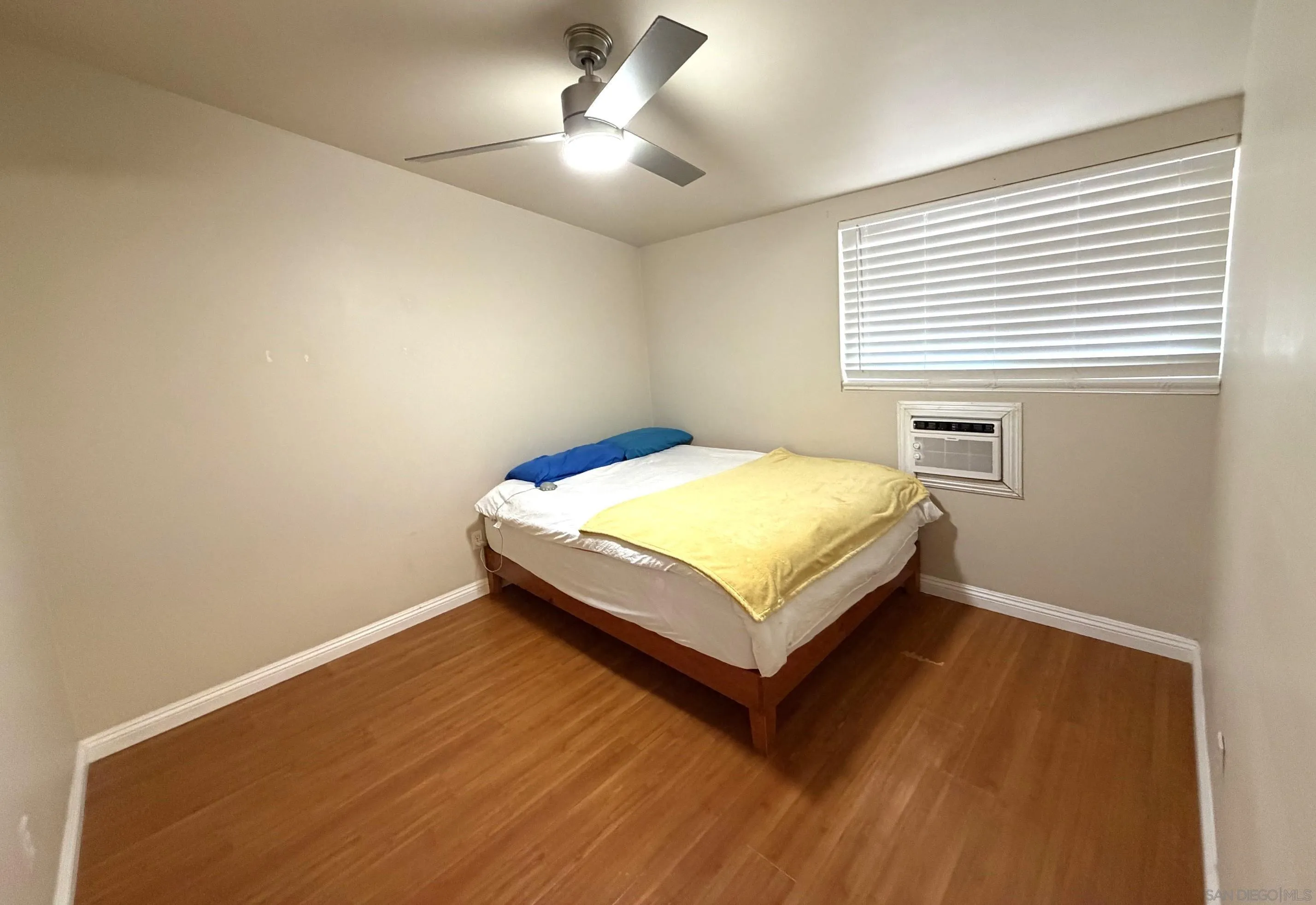 12923 Slack Street Poway, CA 92064 - Photo 20 of 29 a bedroom with a bed and a chandelier