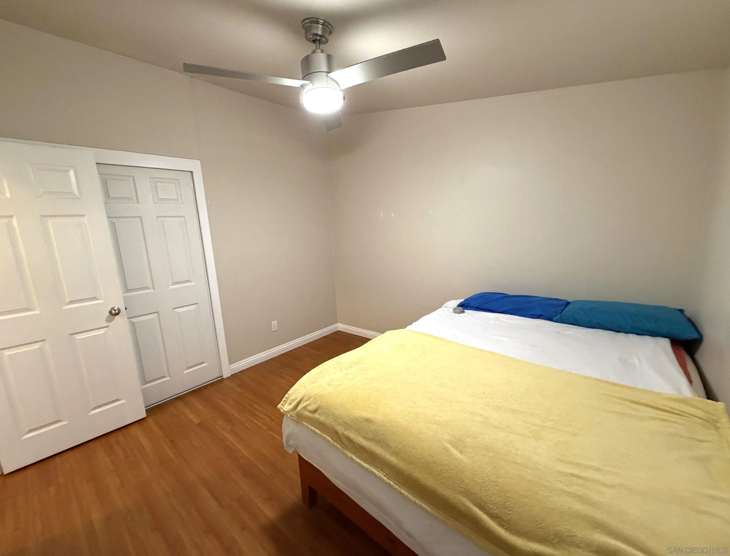 12923 Slack Street Poway, CA 92064 - Photo 21 of 29 a bedroom with a bed and wooden floor