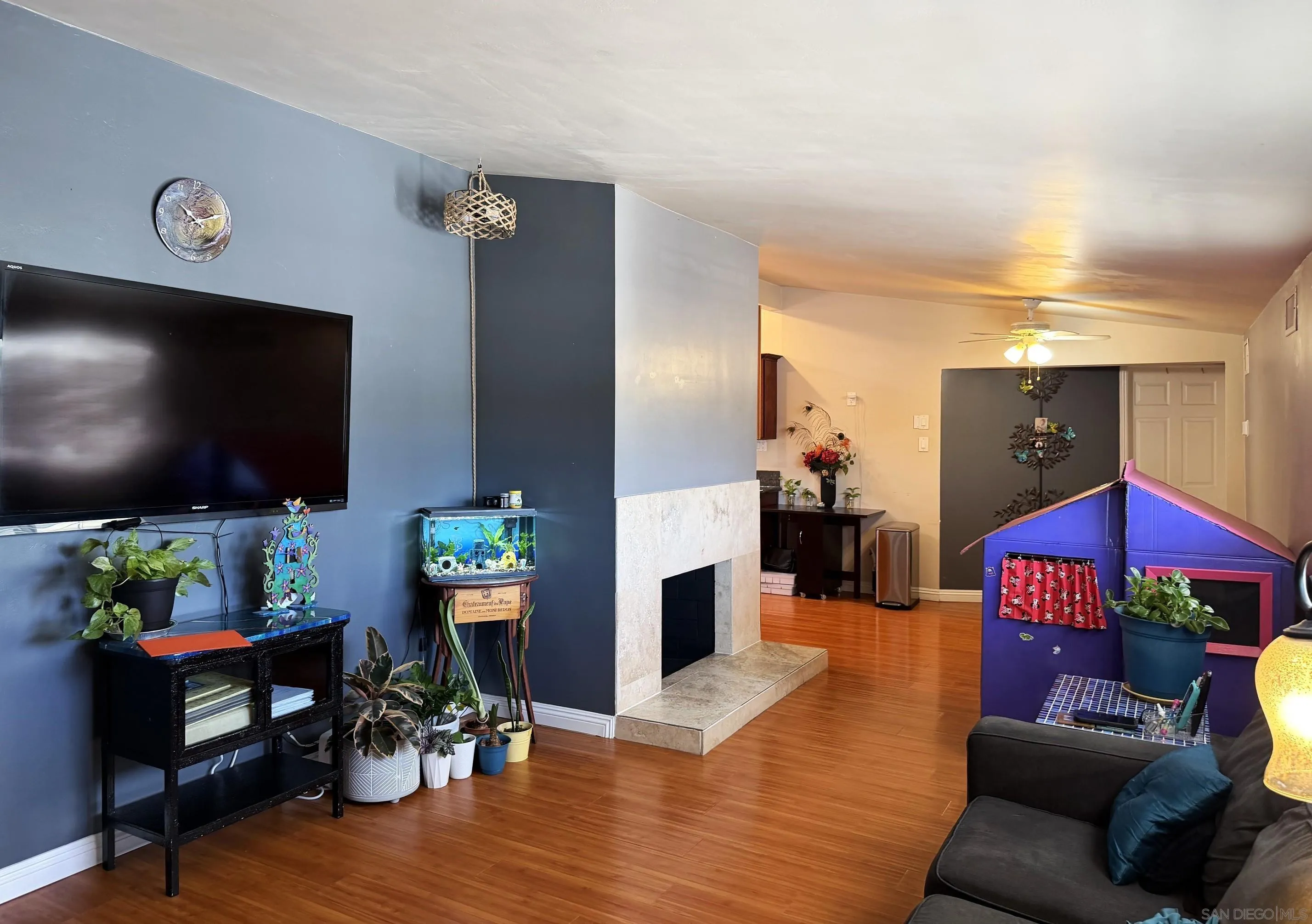12923 Slack Street Poway, CA 92064 - Photo 3 of 29 a living room with furniture and a flat screen tv