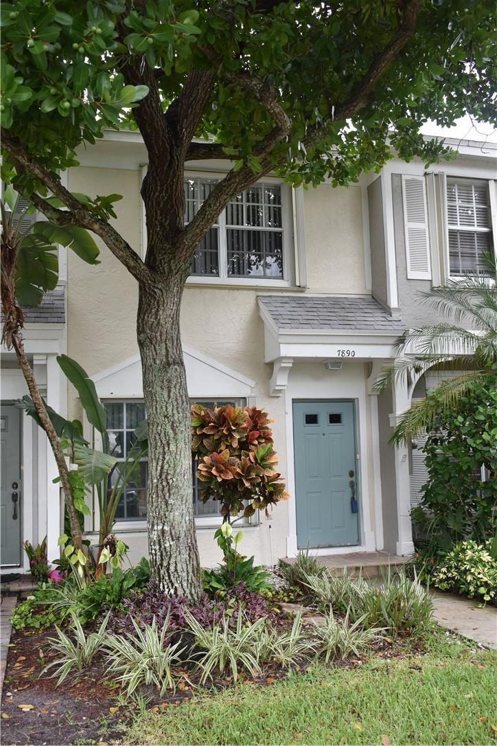 a front view of a house with a yard garage and outdoor seating