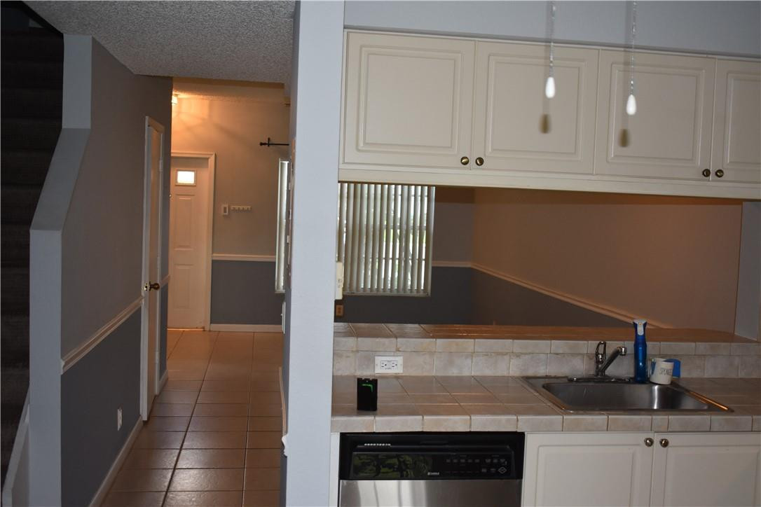 7890 Dixie Beach Circle Tamarac, FL 33321 - Photo 15 of 19 a kitchen with granite countertop white cabinets and sink
